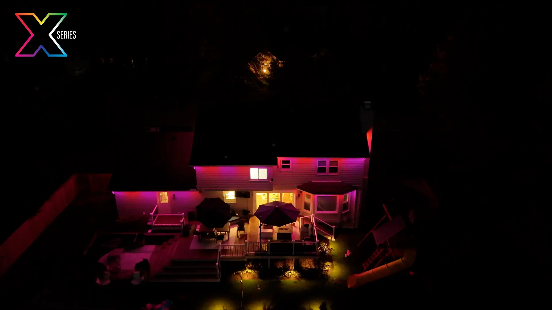 Rear elevation and deck lit in magenta permanent lighting