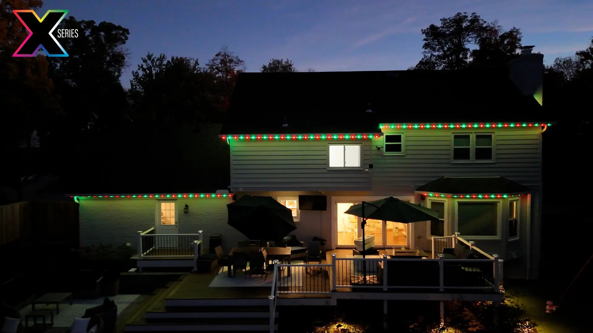 Home and patio outlined in red and green Christmas lighting